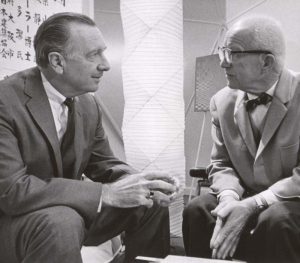 Walter Cronkite interviews Buckminster Fuller during a television broadcast.